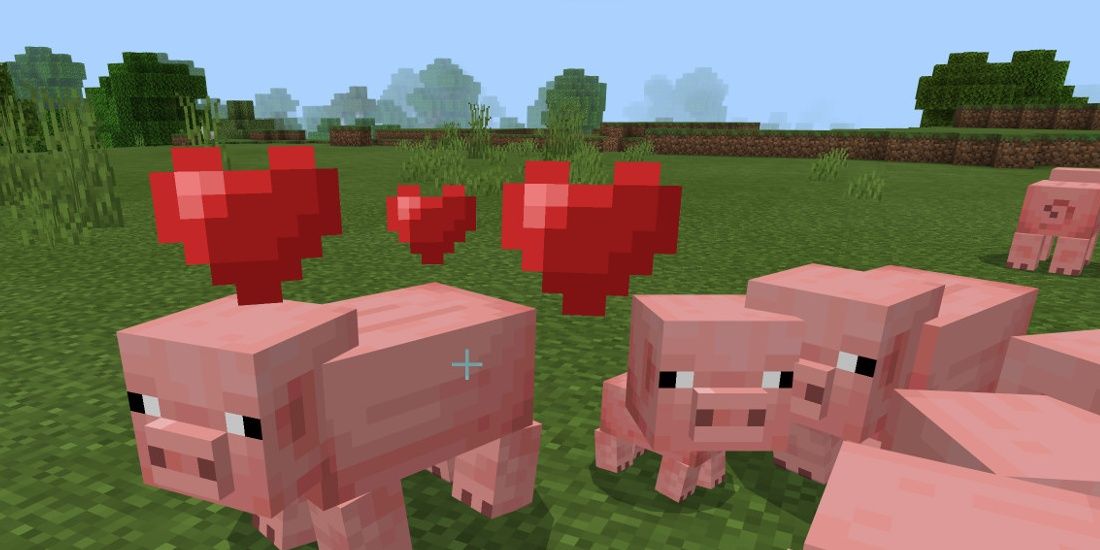 Image of pigs and baby pigs with hearts around them in Minecraft.