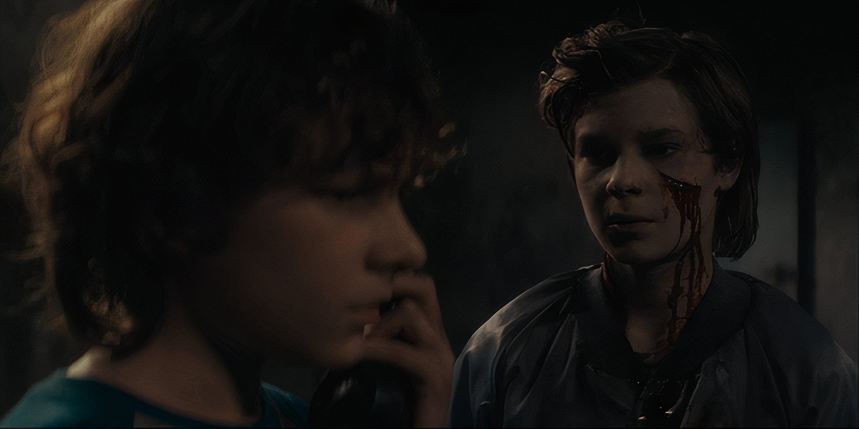 Finney speaking into the supernatural phone as the ghost of Billy appears in The Black Phone.