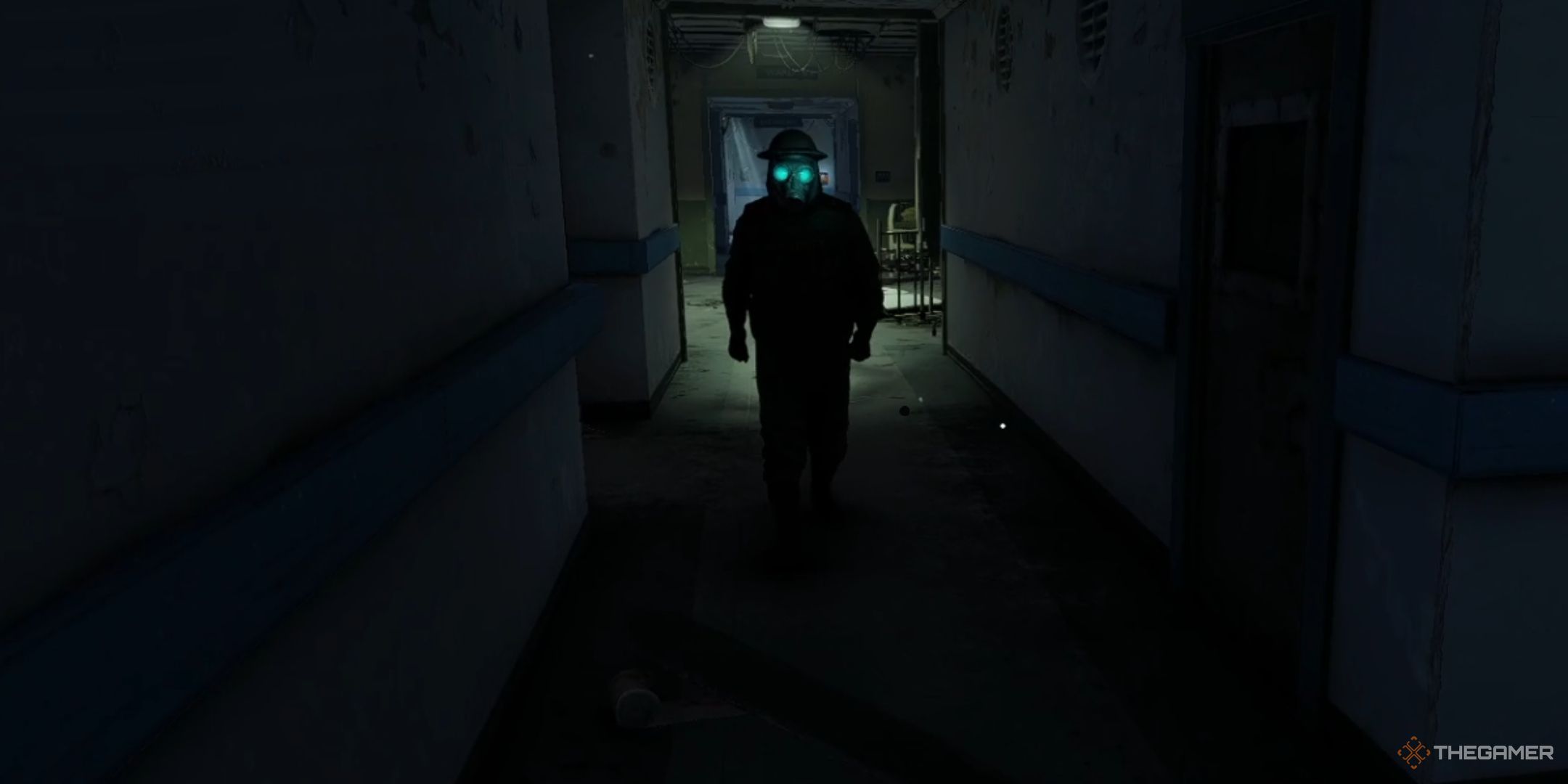 a thrall with glowing blue eyes in a shadowy hallway in atomfall