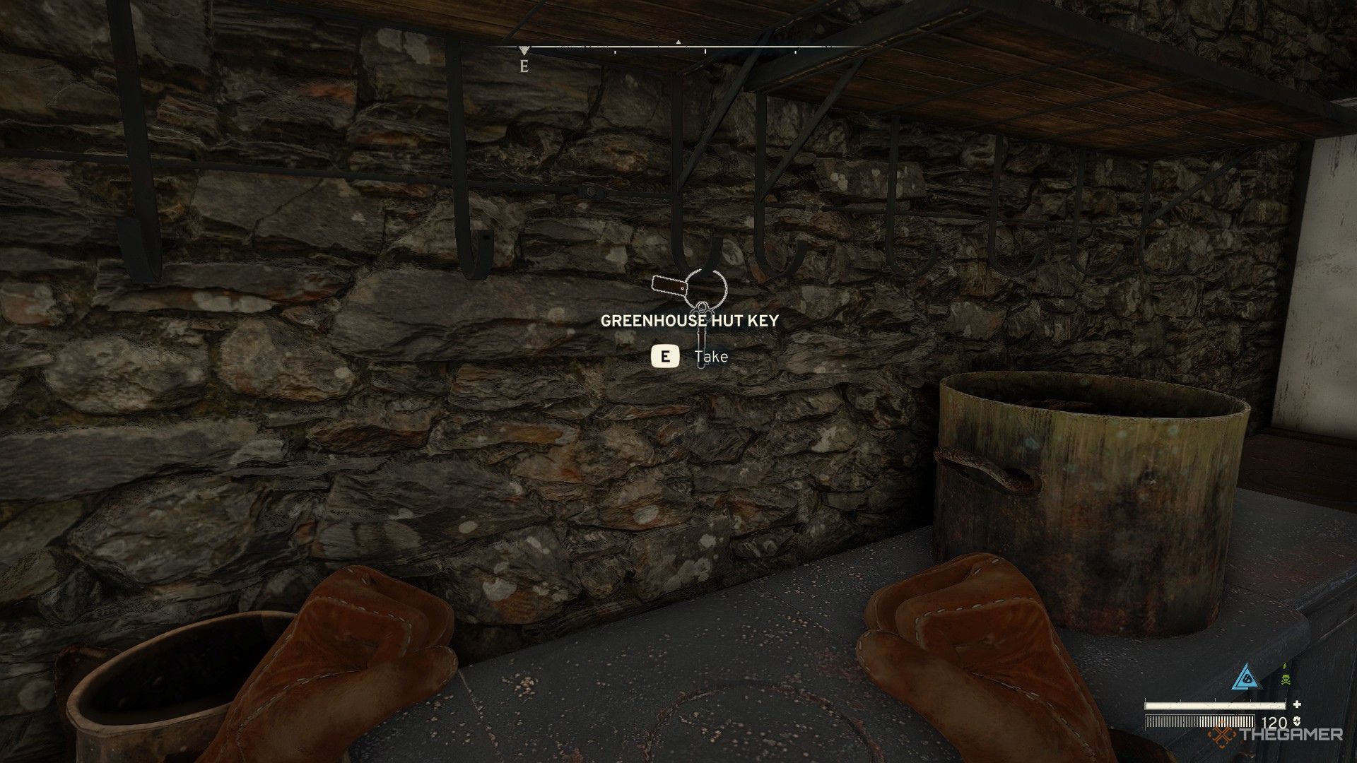 The image shows the Greenhouse Hut Key hanging above the counter in Atomfall.