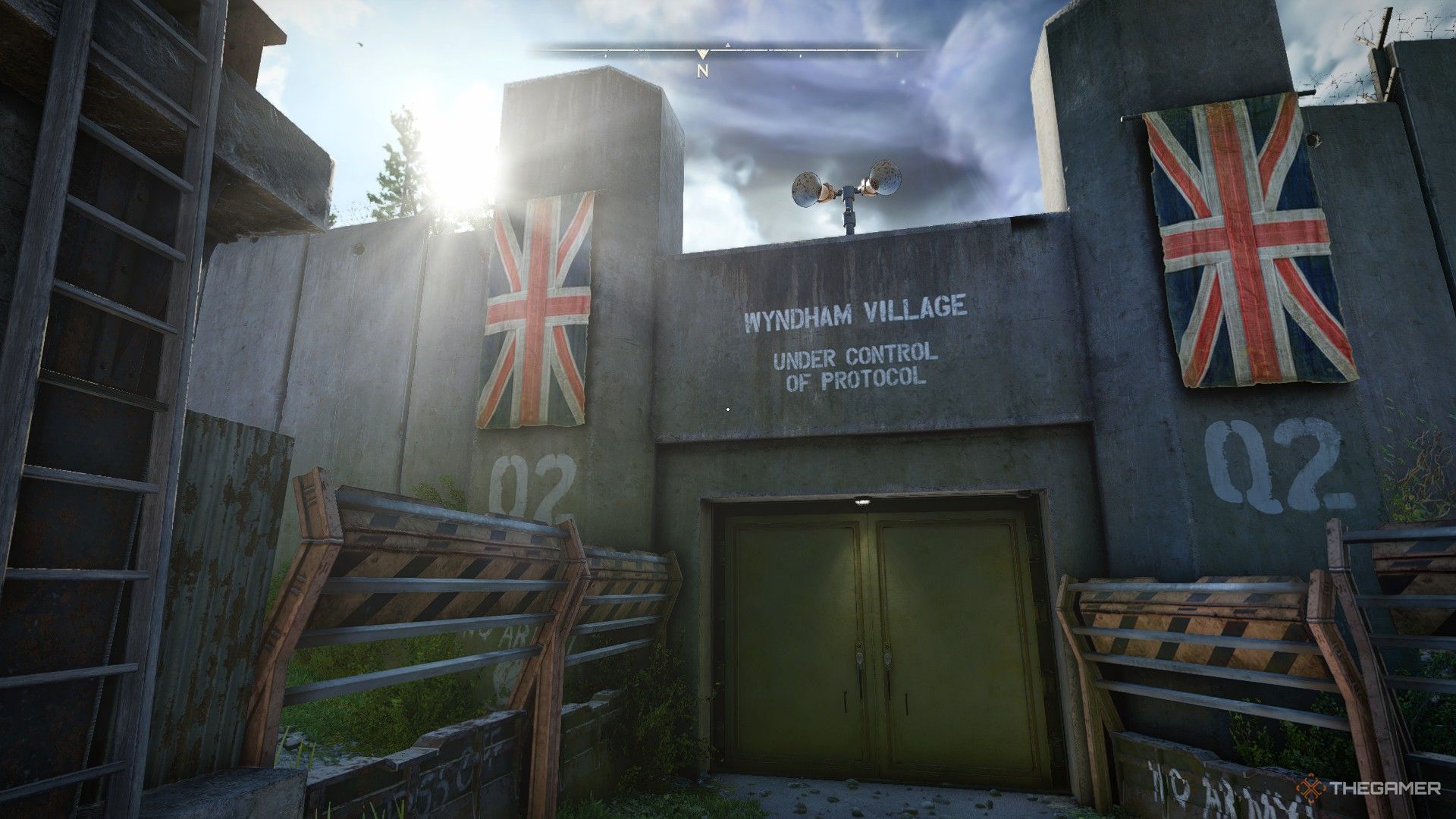 the gate to wyndham village, with two british flags hanging to either side, in atomfall.