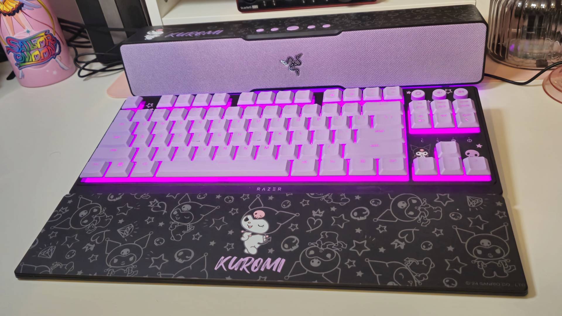 Photos taken by writer Rosalie Newcombe of the Razer Ornata V3 Tenkeyless Kuromi Edition gaming keyboard, on a white desk. 