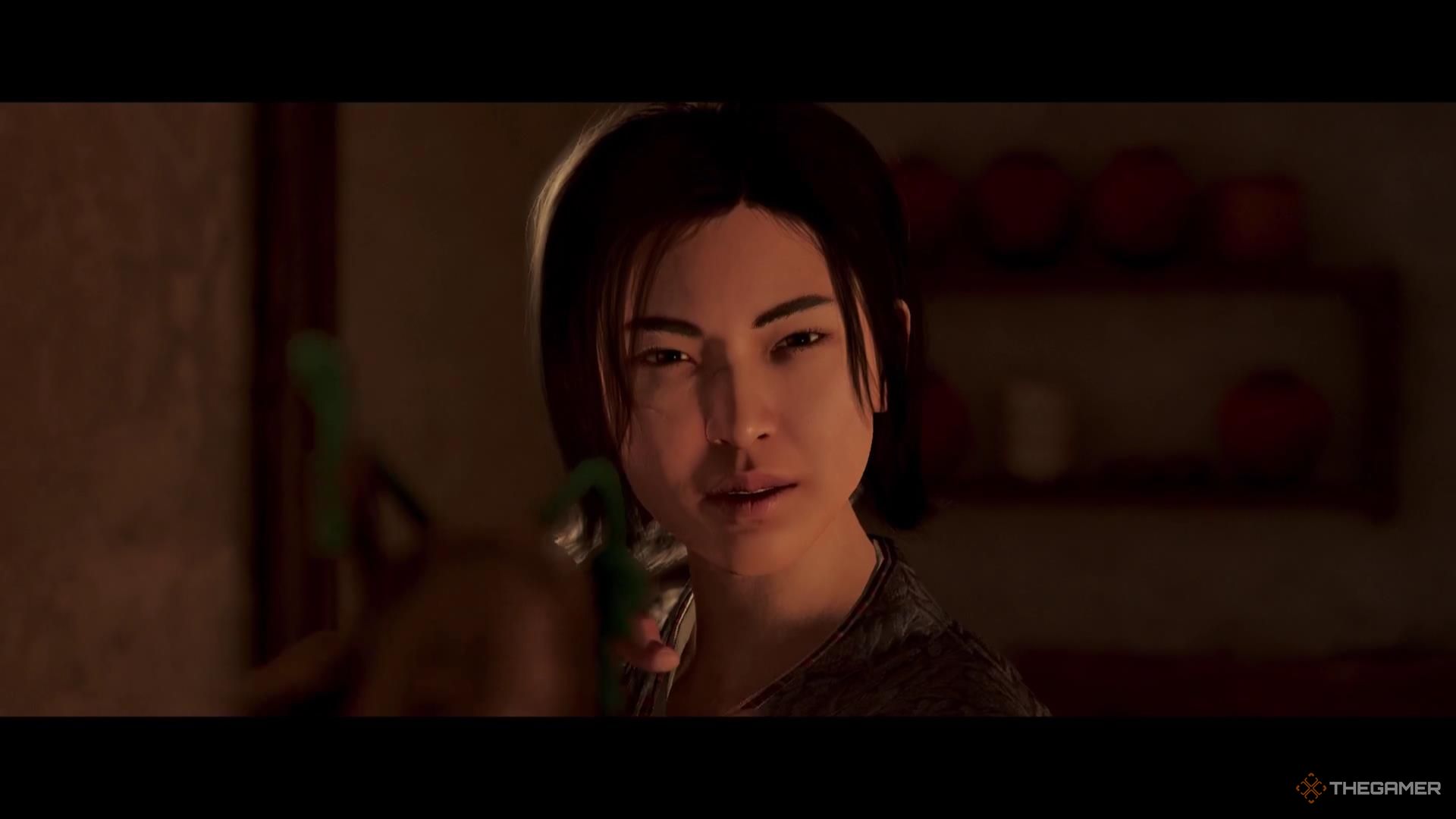 Naoe stares down the barrel of a firearm in Assassin's Creed Shadows.