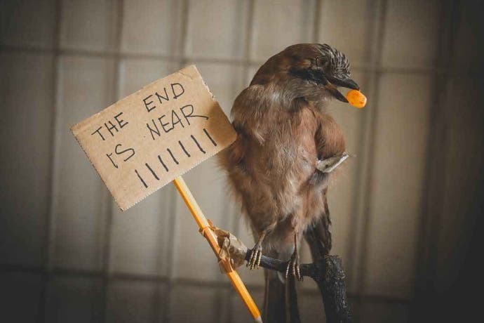 A bird holds a sign in its feet that says