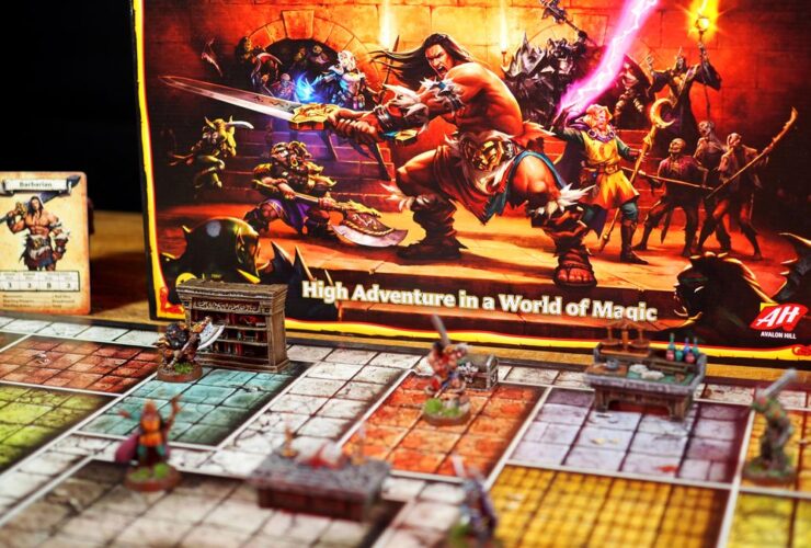 HeroQuest box, models, tokens, board, and cards on a wooden table