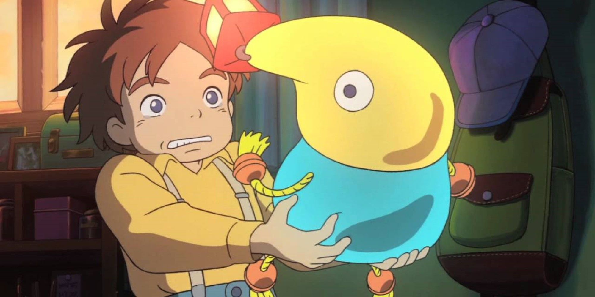Oliver holding Mr Drippy as he comes alive in Ni No Kuni: Wrath of the White Witch.