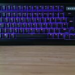 Razer BlackWidow V4 Pro 75% gaming keyboard with purple RGB lighting on a desk setup