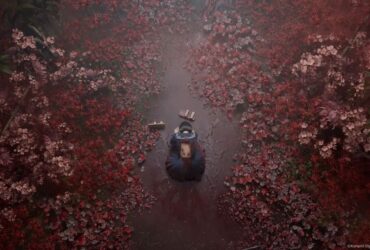 A top down view of a schoolgirl on the floor surrounded by blood-red leaves in Silent Hill f