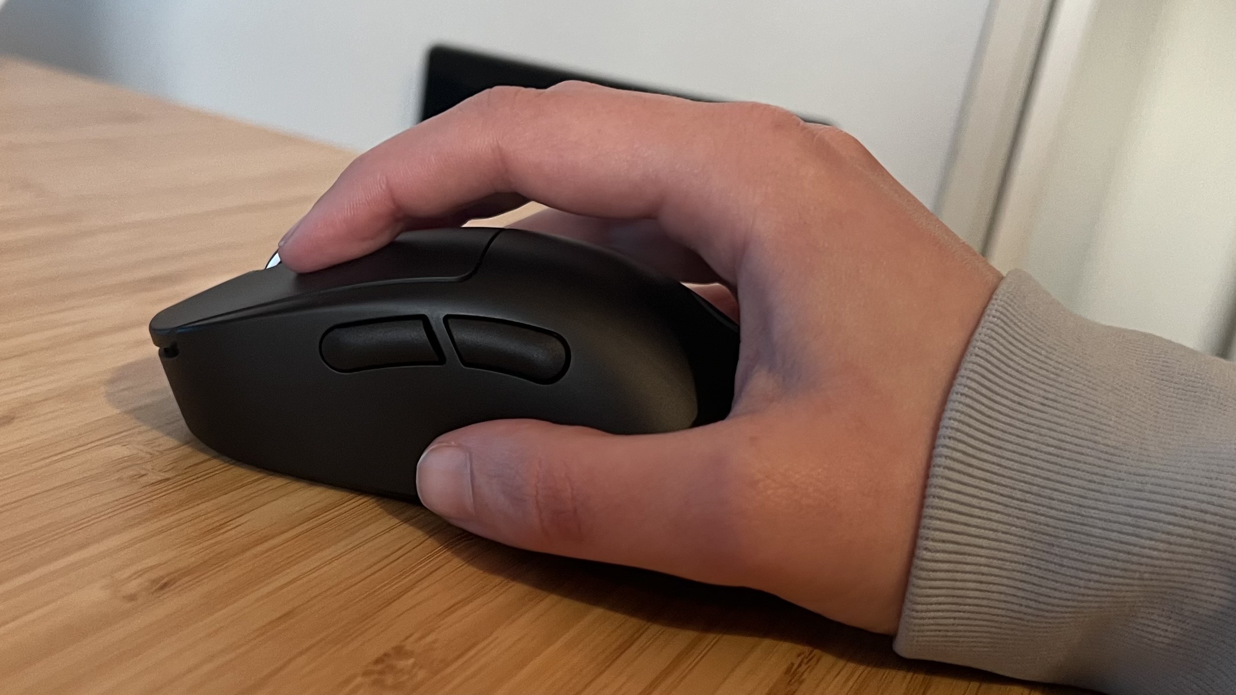 Hand using the Logitech G Pro X Superlight 2 DEX gaming mouse in a relaxed claw grip