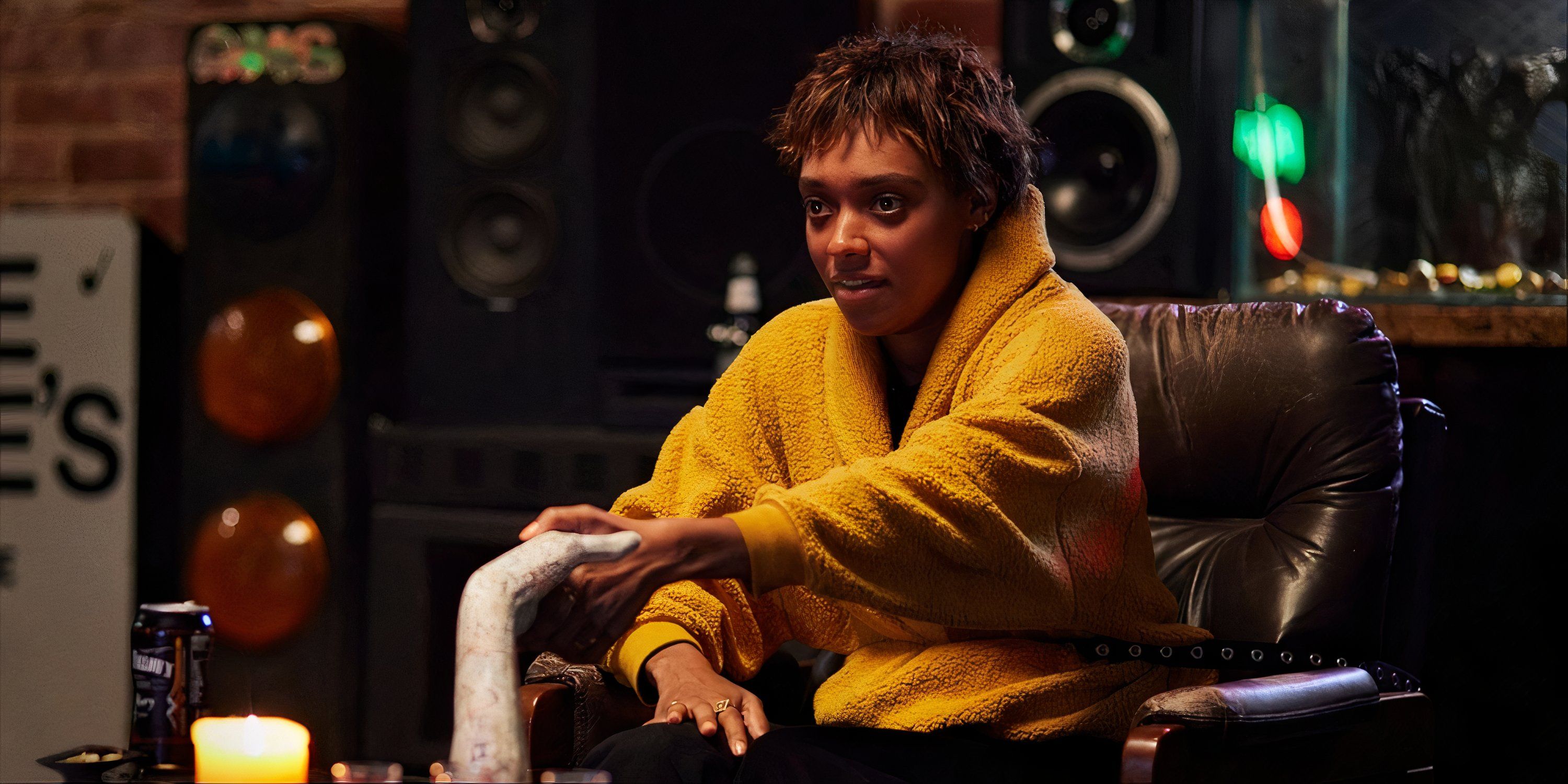 Sophie Wilde in a yellow coat grabbing the hand that allows you to encounter spirits in Talk to Me.