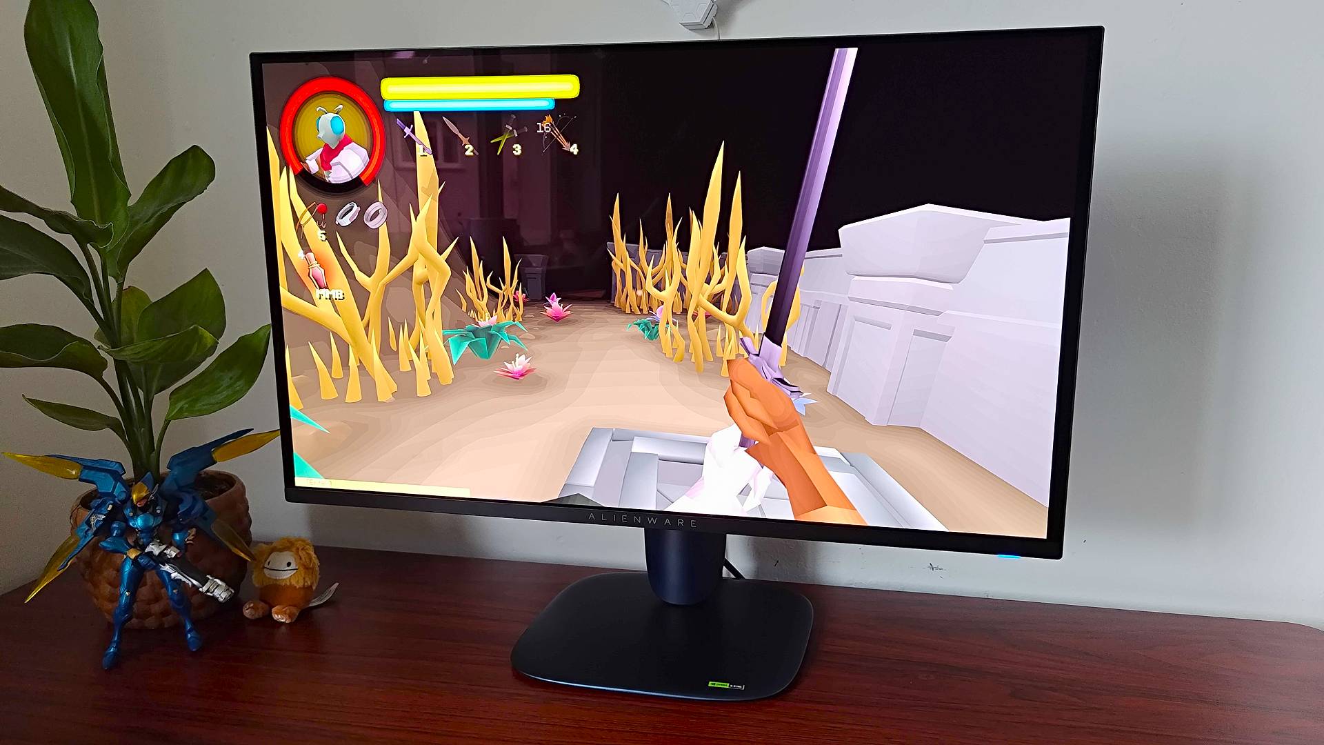 Alienware AW2725Q gaming monitor with FlyKnight gameplay on screen featuring player character holding sword.