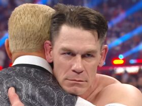 John Cena stares evilly while embracing Cody Rhodes