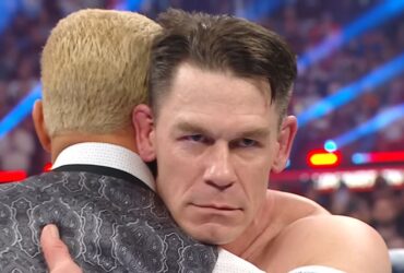 John Cena stares evilly while embracing Cody Rhodes