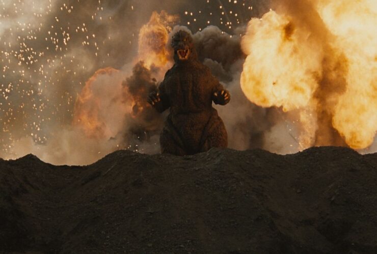 Godzilla emerging from an exploding volcano.