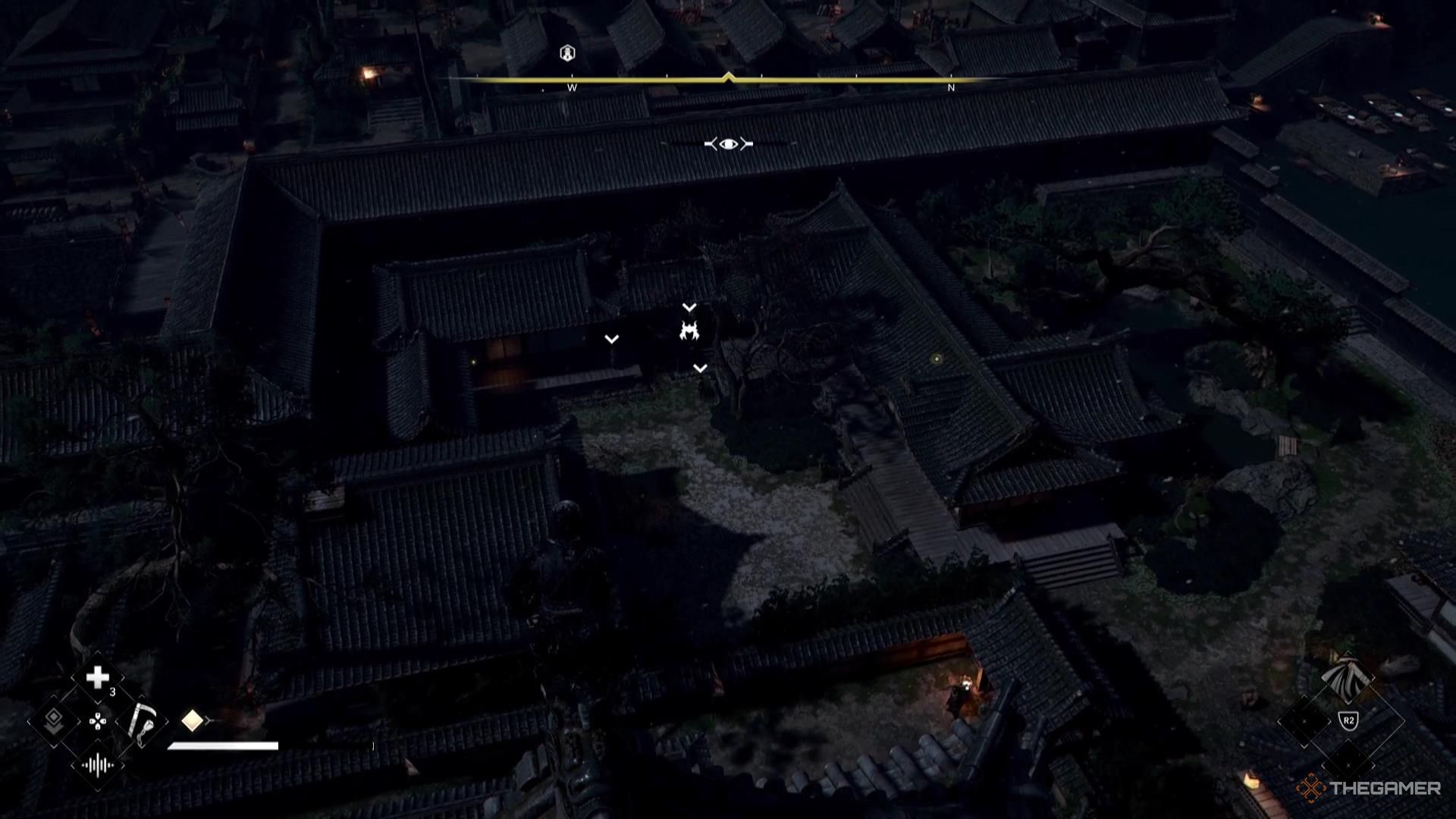 A samurai stands in a darkened courtyard in Assassin's Creed Shadows.