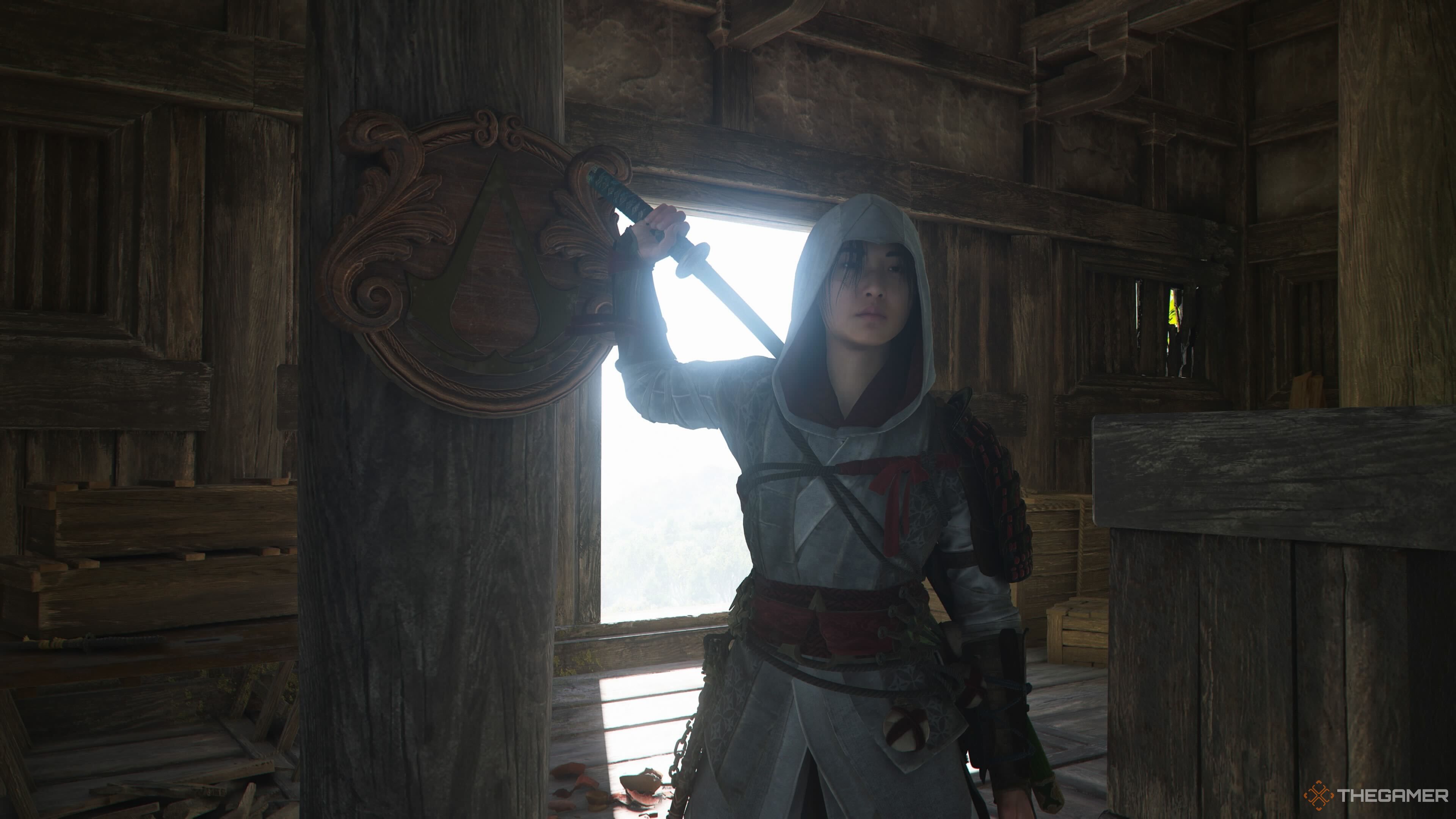 Naoe standing in an assassin outpost in Assassin's Creed Shadows.