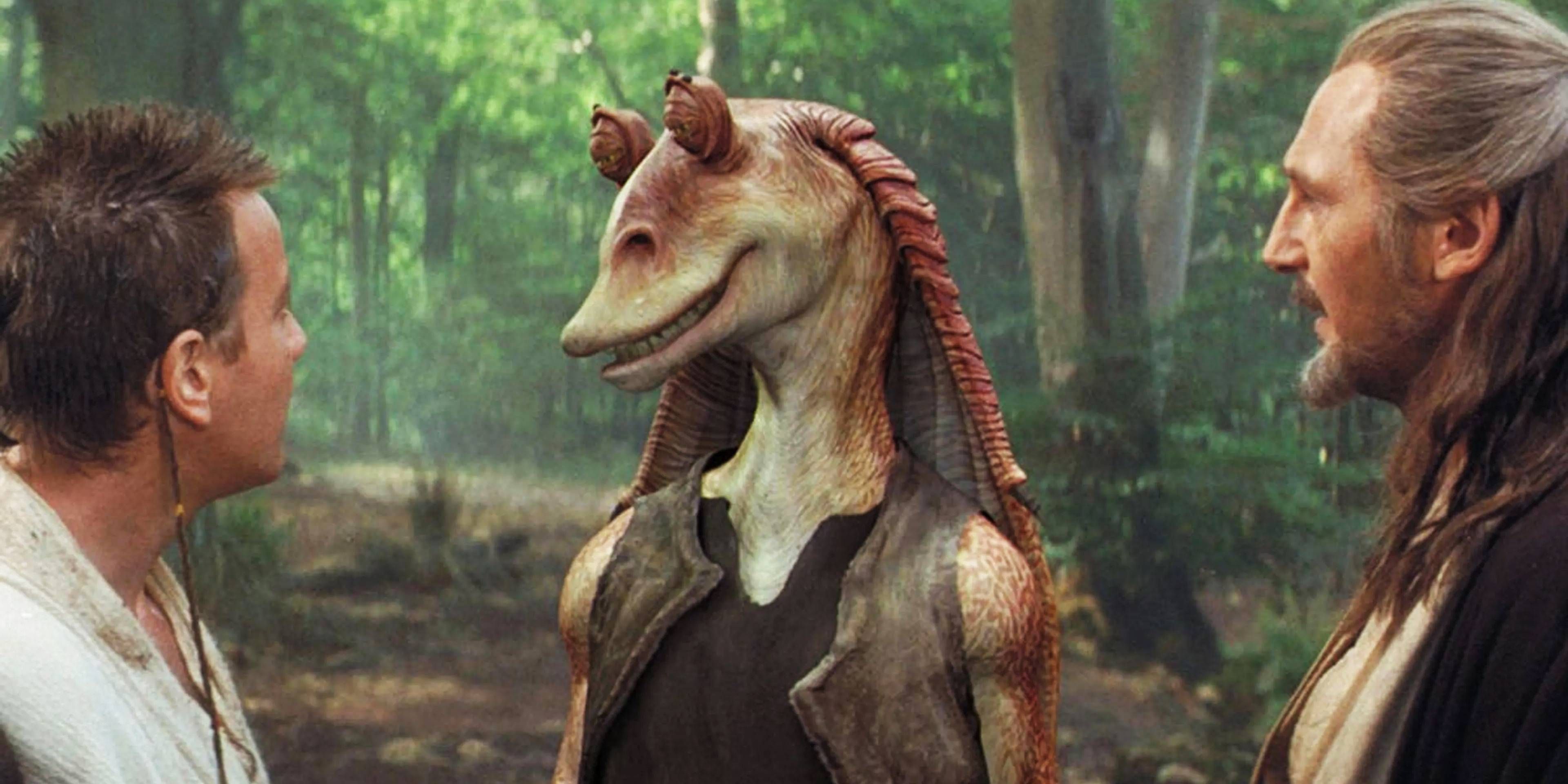 Jar Jar Binks smiling at Obi-Wan Kenobi and Qui-Gon Jinn in Star Wars: Episode 1: The Phantom Menace.