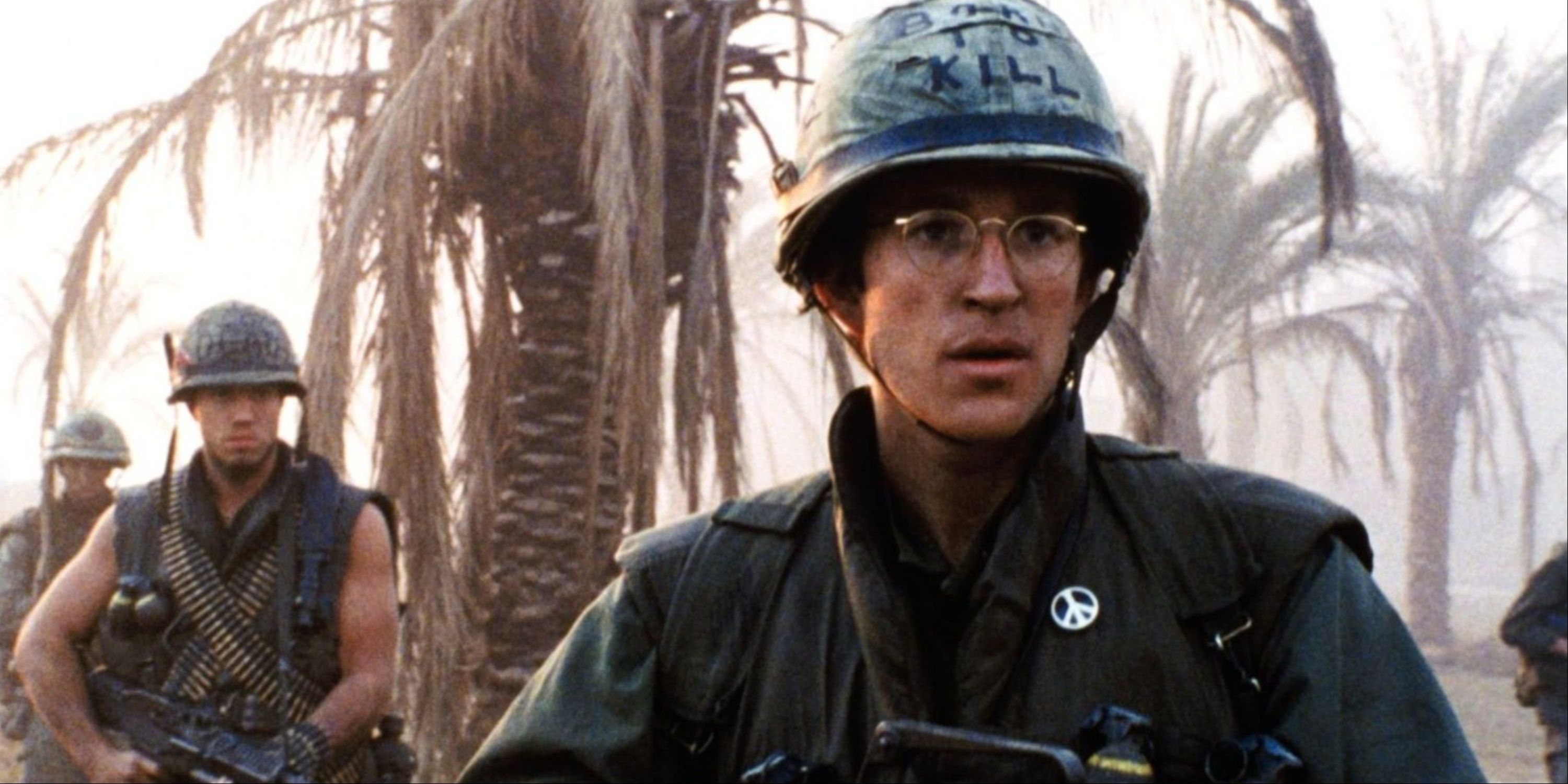 Joker and other soldiers marching behind him in the battlefield in Full Metal Jacket.