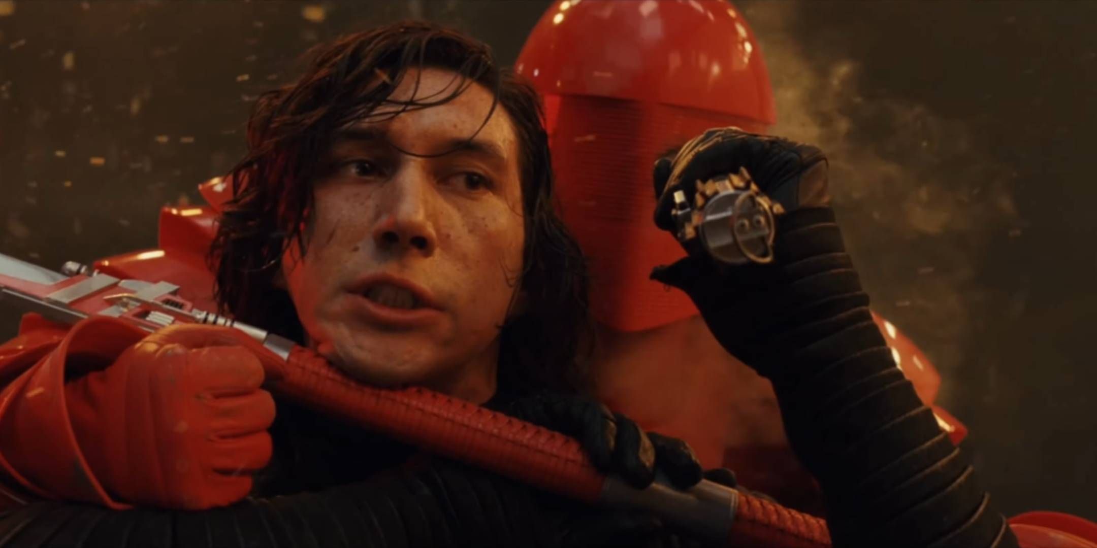 Kylo Ren aka Ben Solo holding Luke's lightsaber after Rey threw it to him to defeat an Elite Praetorian Guard in Star Wars: Episode 8 - The Last Jedi.