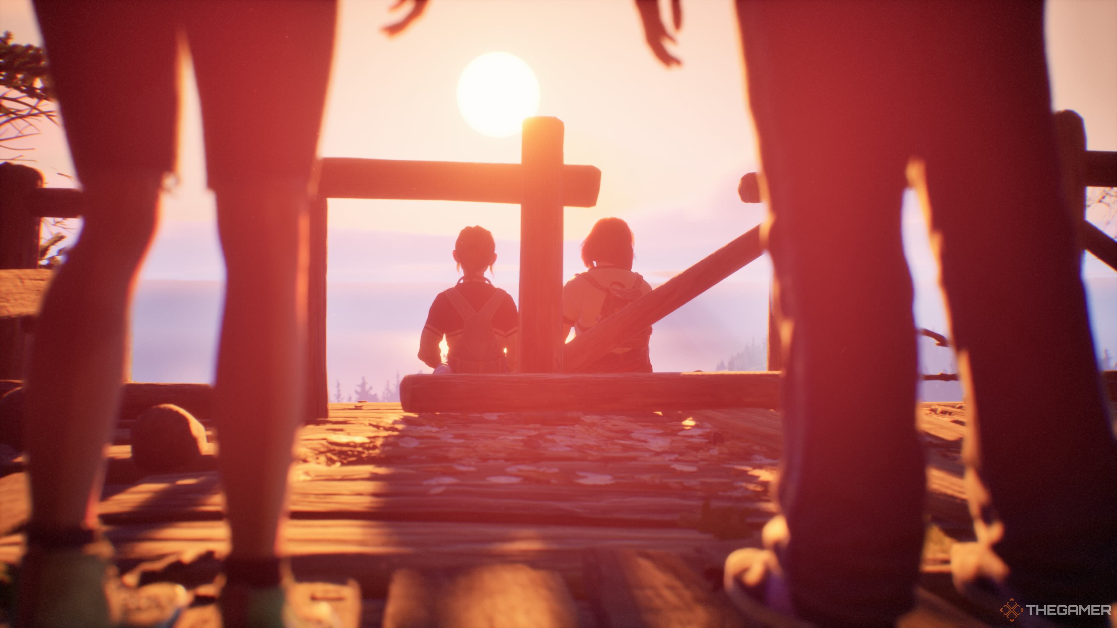 Kat and Swann sit on the edge of a scenic overlook, as Autumn and Nora look on in Lost Records: Bloom & Rage.