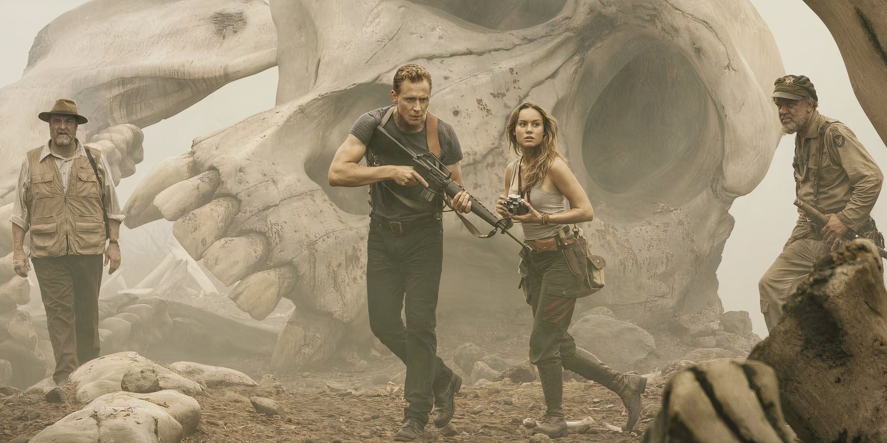 Mason Weaver and James Conrad stand together in front of a giant skull in Kong Skull Island.