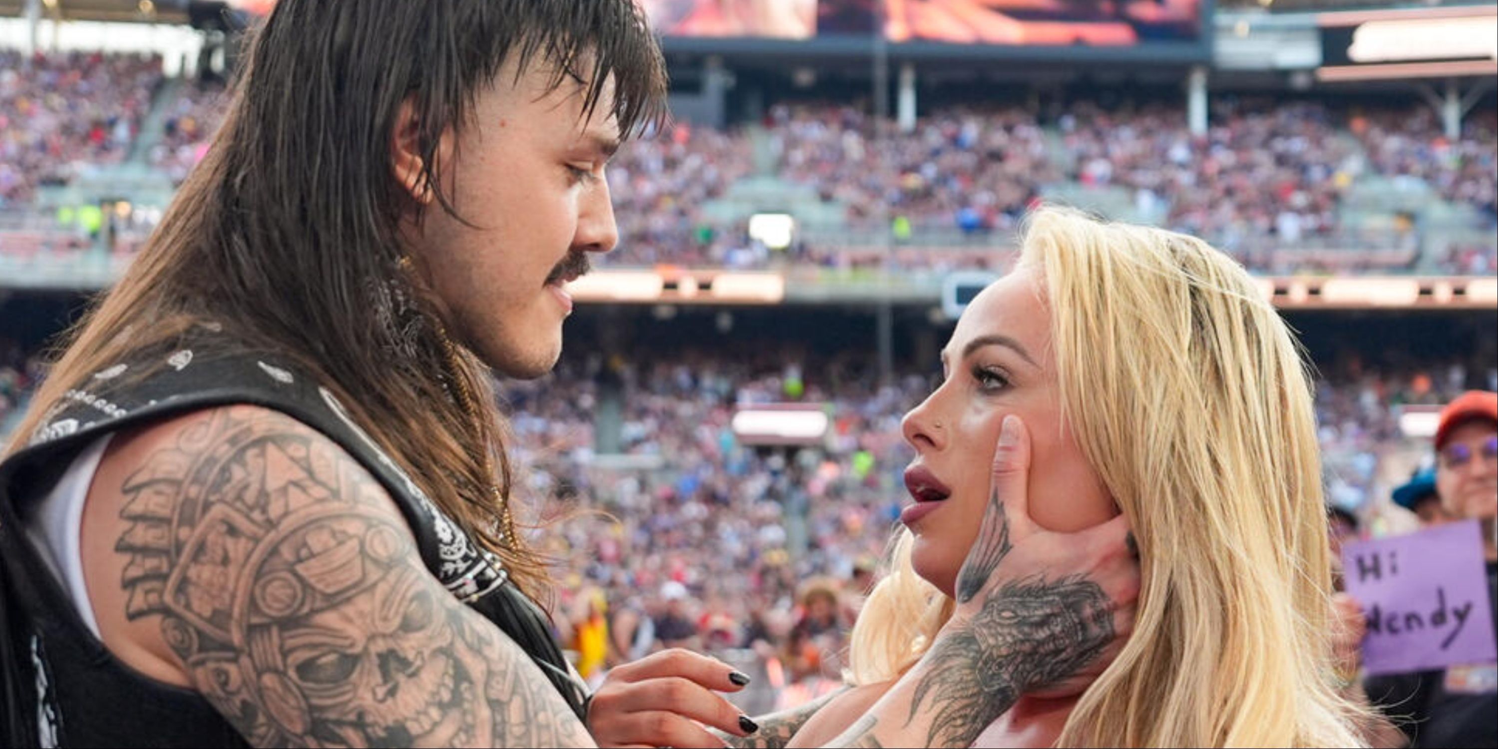 Dominik Mysterio and Liv Morgan about to kiss at SummerSlam 2024.