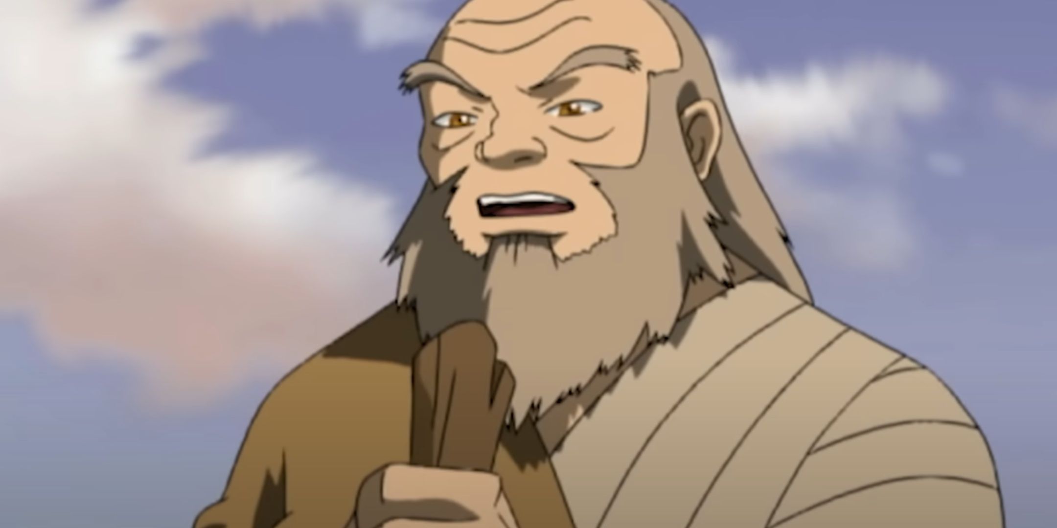 Iroh holds a stick as he lectures Zuko.