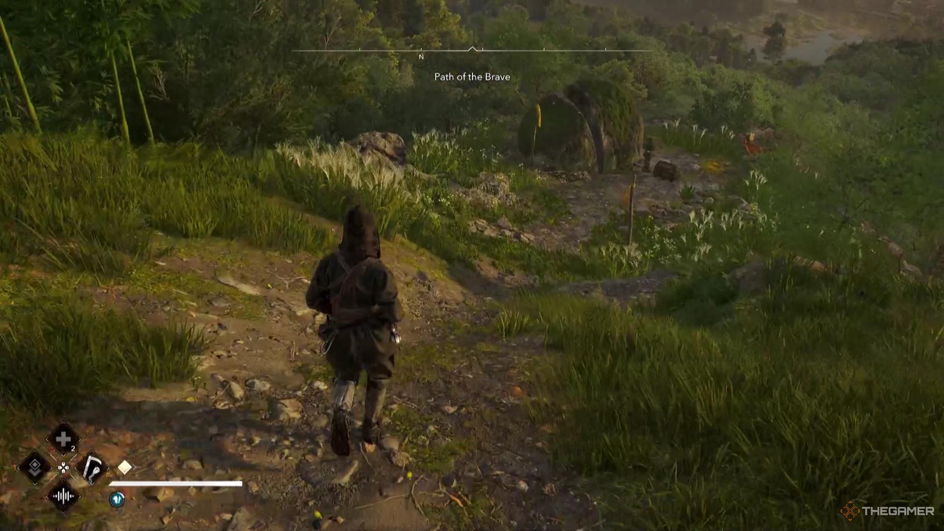 Naoe walks down a small hill toward a chest in Assassin's Creed Shadows.