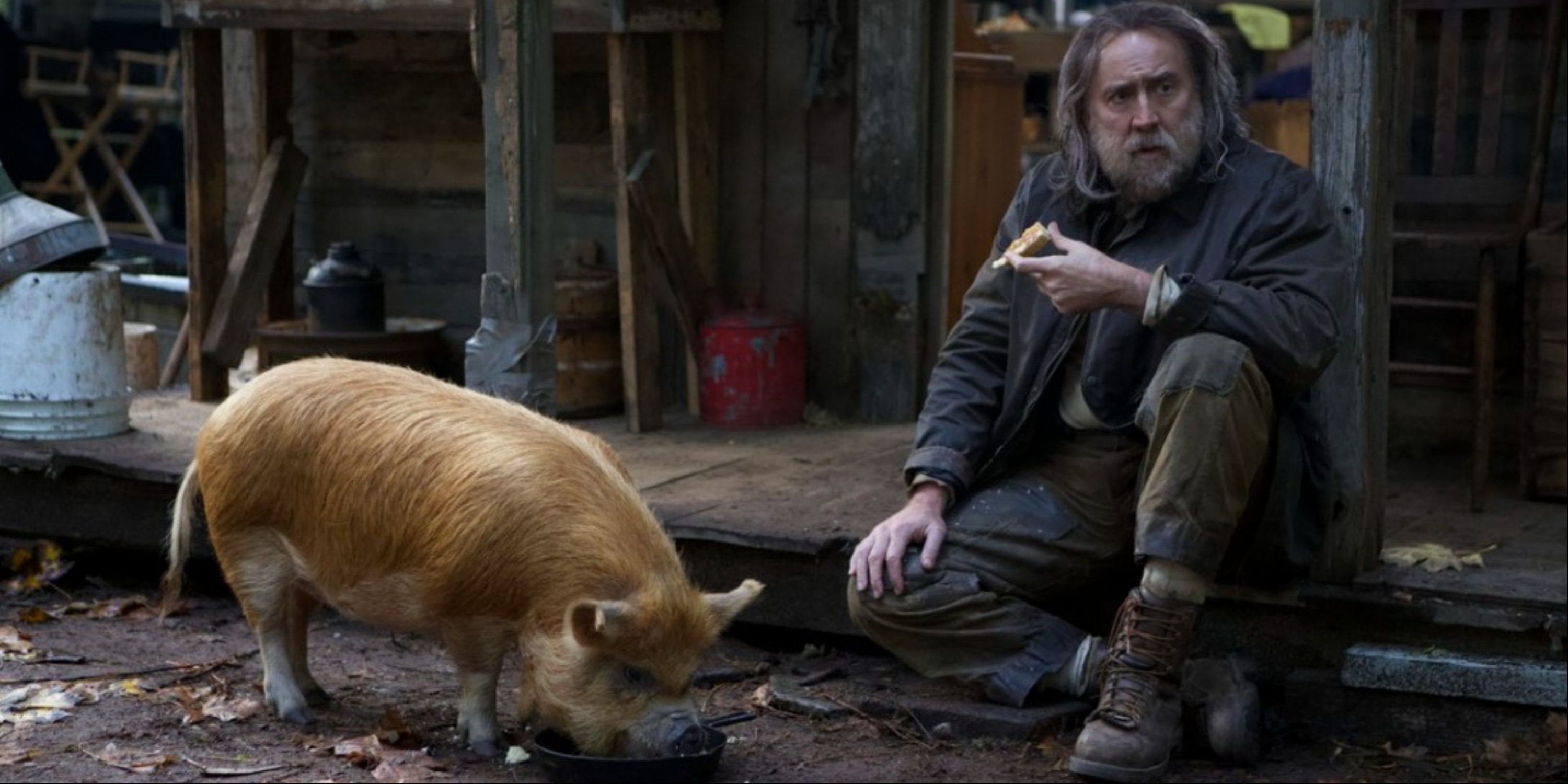 Nicolas Cage and his pig both eating on the street in Pig.