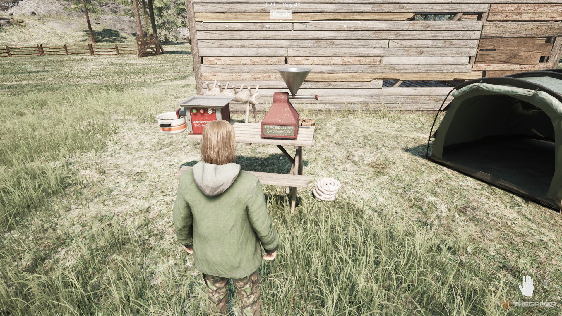 The player is standing next to a table that has sausage stuffer and meat grinder on it in Ranch Simulator