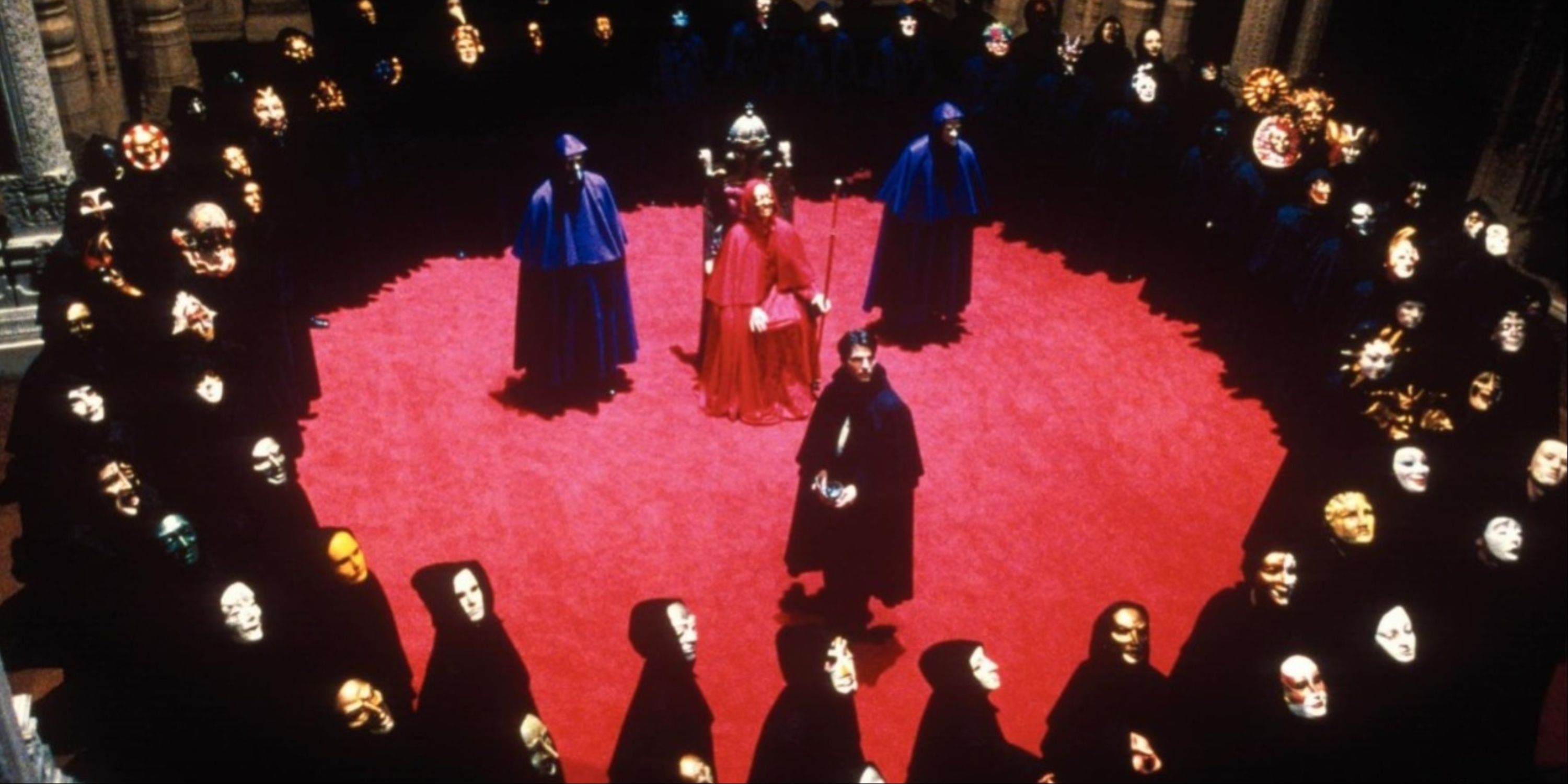 Tom Cruise surrounded by a sea of masked men at a secret society gathering in Eyes Wide Shut.