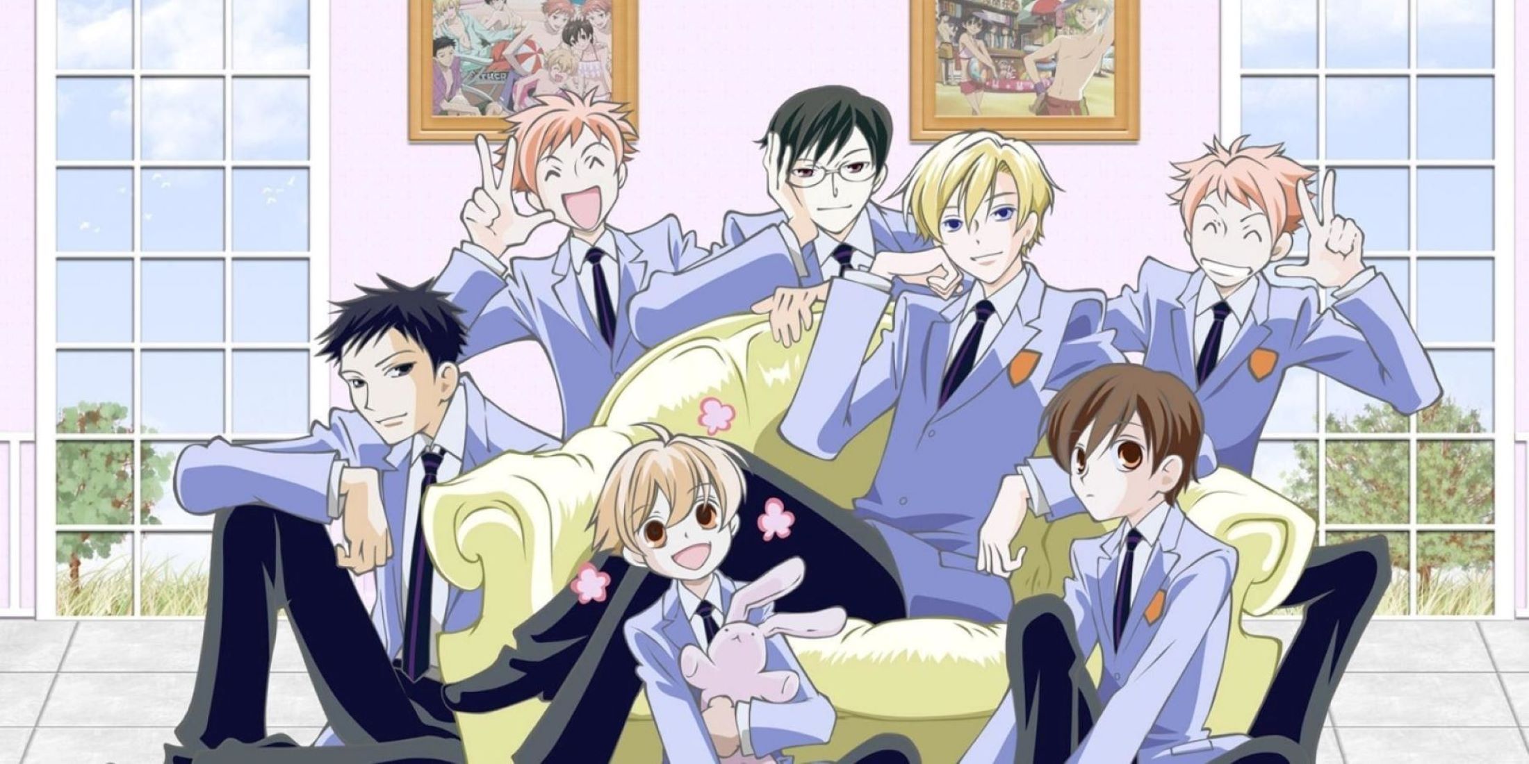 Whole host club group posing together on and around a sofa