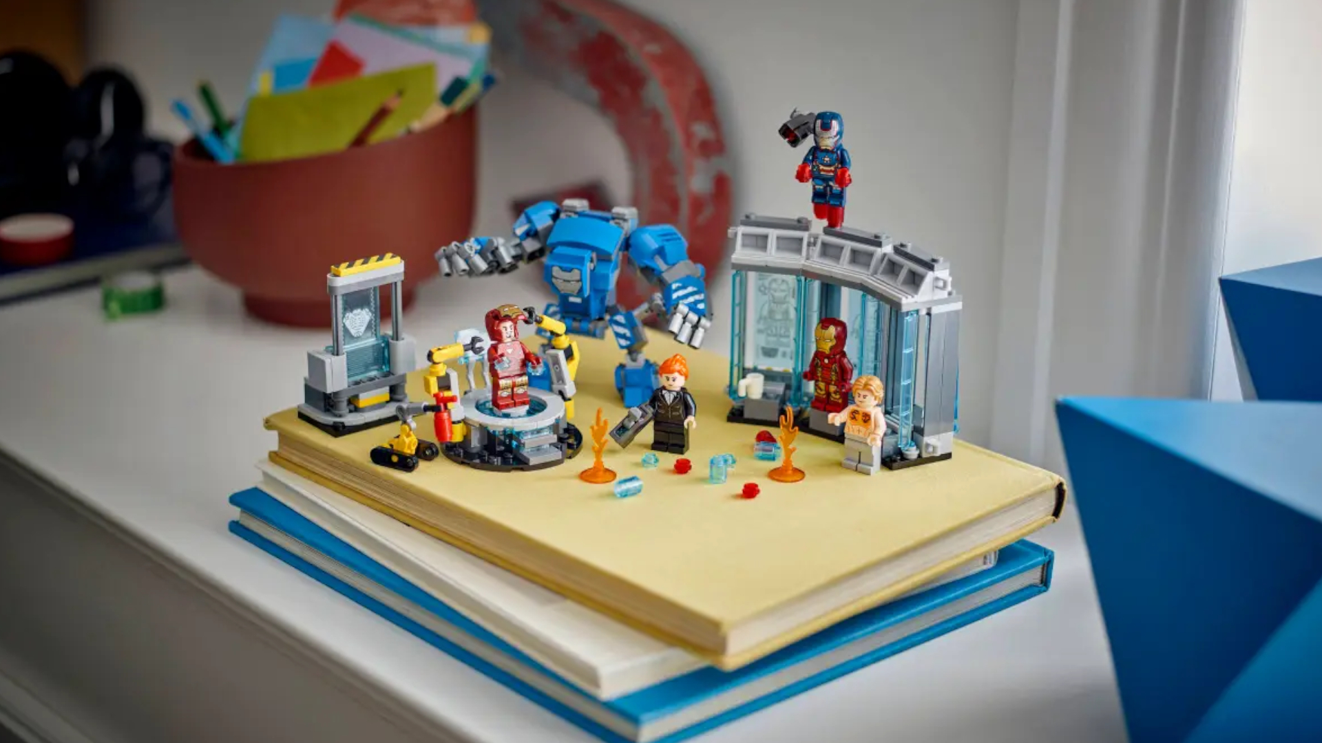 Lego Iron Man's Laboratory set on a pile of books