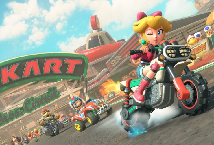 Mario Kart World screenshot showing Peach on a bike, racing ahead of Mario, Bowser, and other racers.