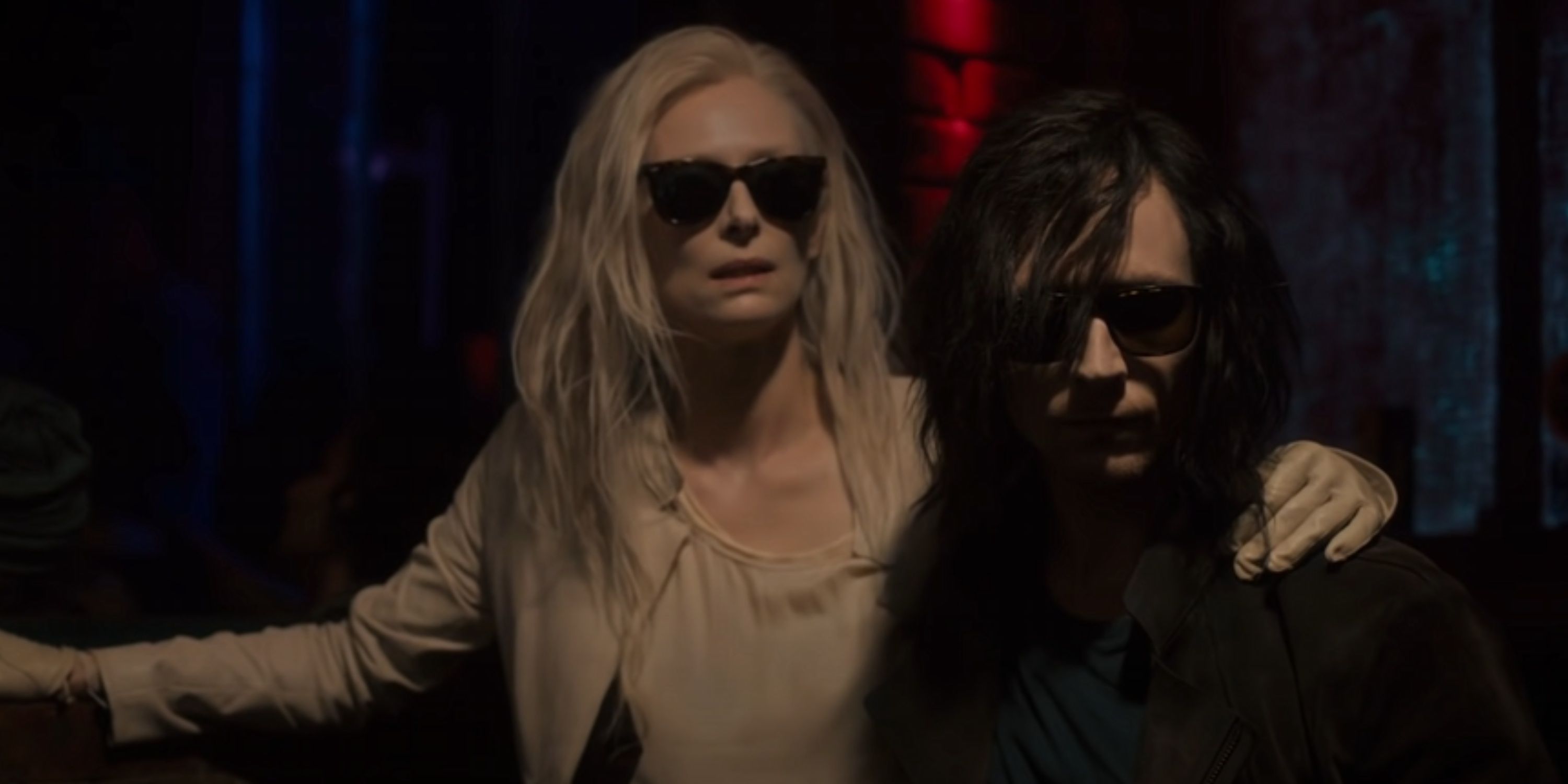 Adam and Eve wear shades in a nightclub.