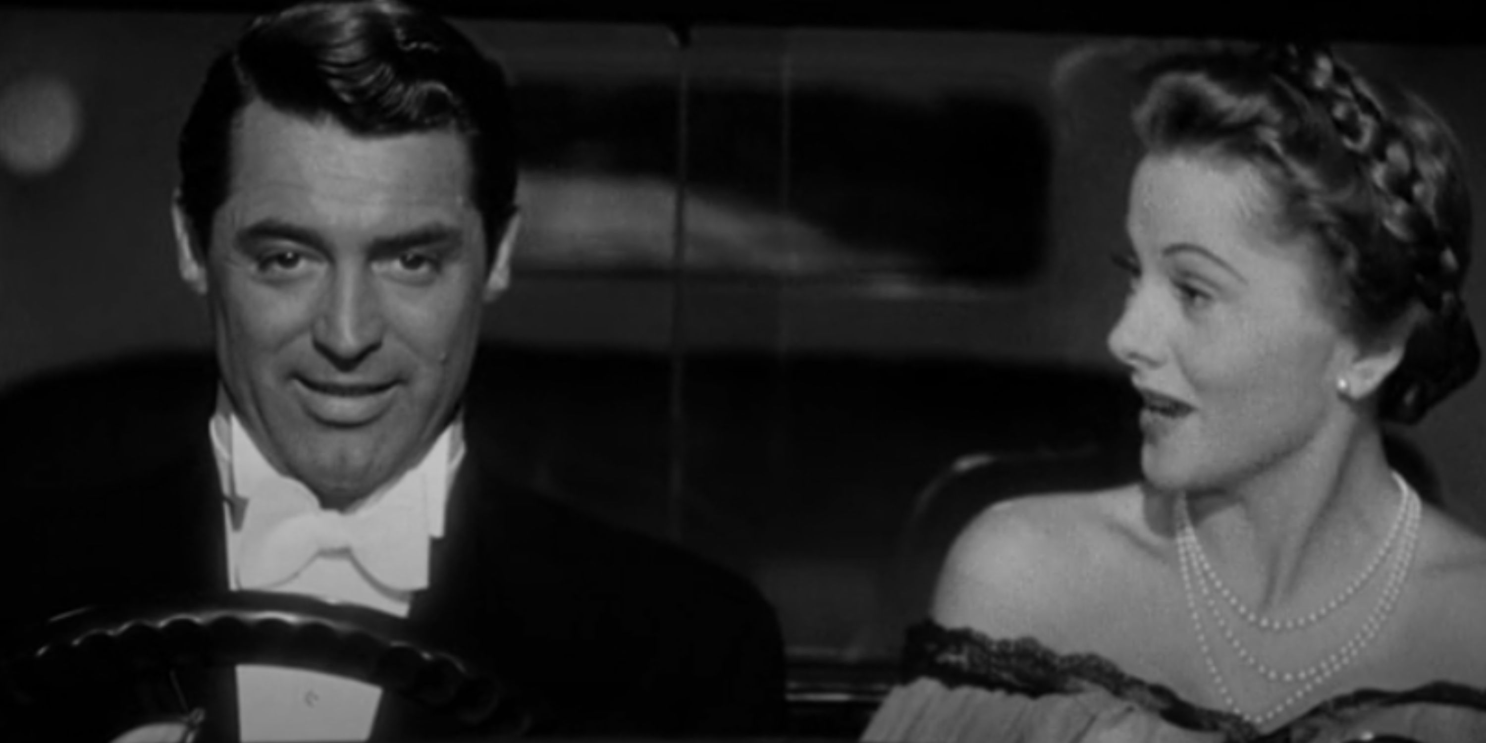 Johnnie and Lina talk as they drive a motorcar.