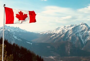 Canadian Flag in front of a mountain range