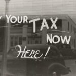 Pay your tax here now written on a window