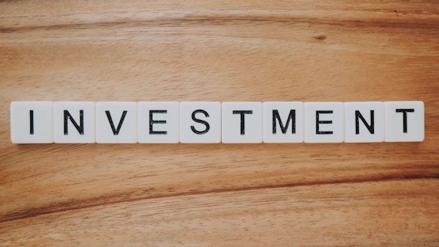 Investment spelled out in scrabble-esque tiles