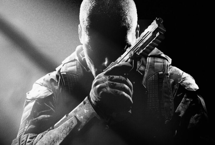 Key art for Call of Duty Black Ops 2 showing a character sitting in darkness with a handgun, from Edge 353