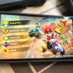 Photo by Rosalie Newcombe of the Nintendo Switch 2 sitting on a coffee table surrounded by accessories.