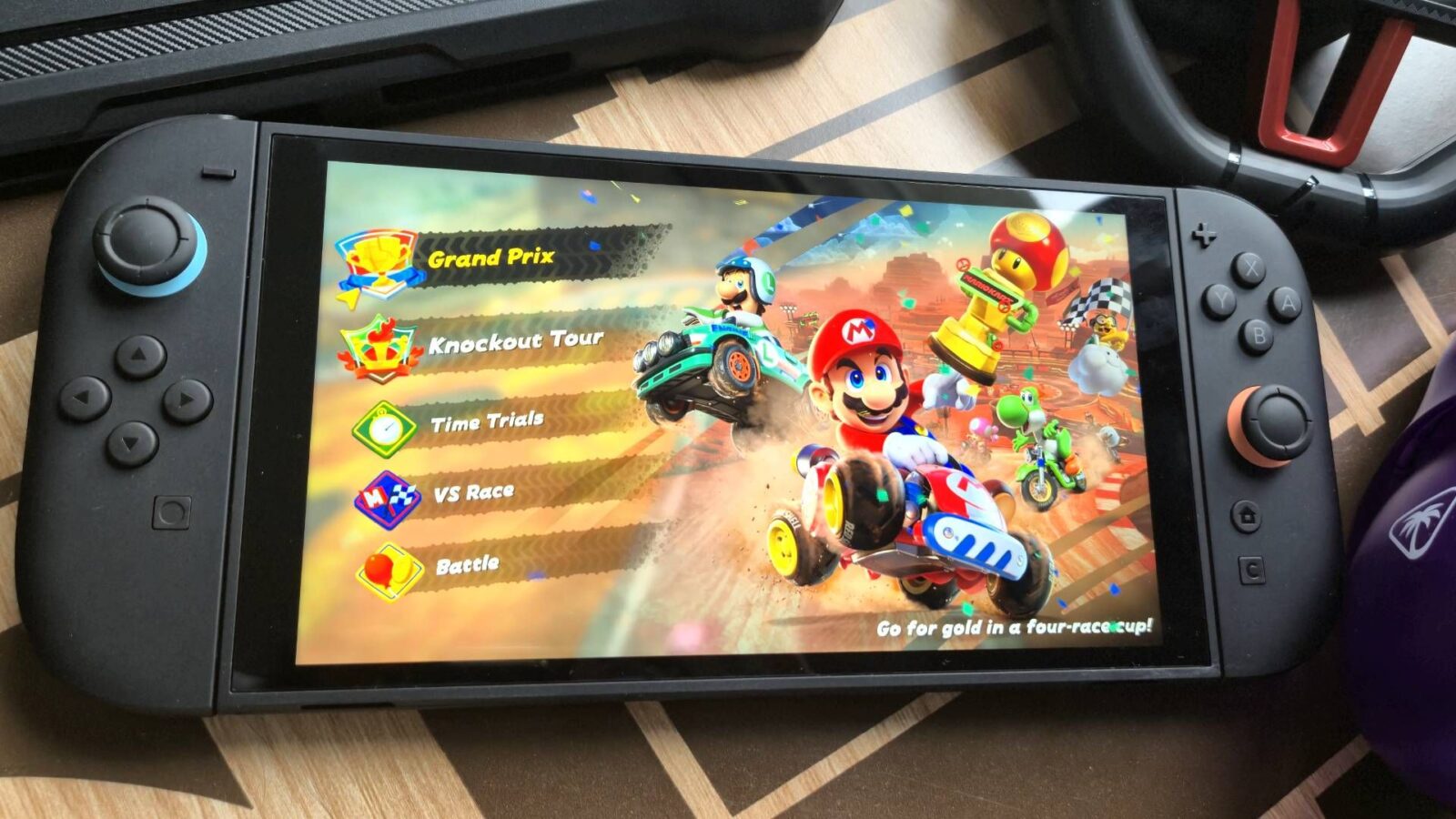 Photo by Rosalie Newcombe of the Nintendo Switch 2 sitting on a coffee table surrounded by accessories.