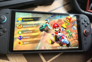 Photo by Rosalie Newcombe of the Nintendo Switch 2 sitting on a coffee table surrounded by accessories.