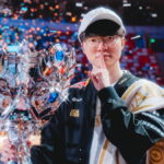 T1 team celebrates their League of Legends LCK championship victory on stage with the trophy
