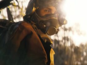 Arc Raiders raider in a pilot helmet looks at the camera in a sunlit forest