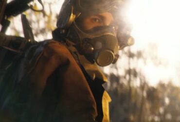 Arc Raiders raider in a pilot helmet looks at the camera in a sunlit forest