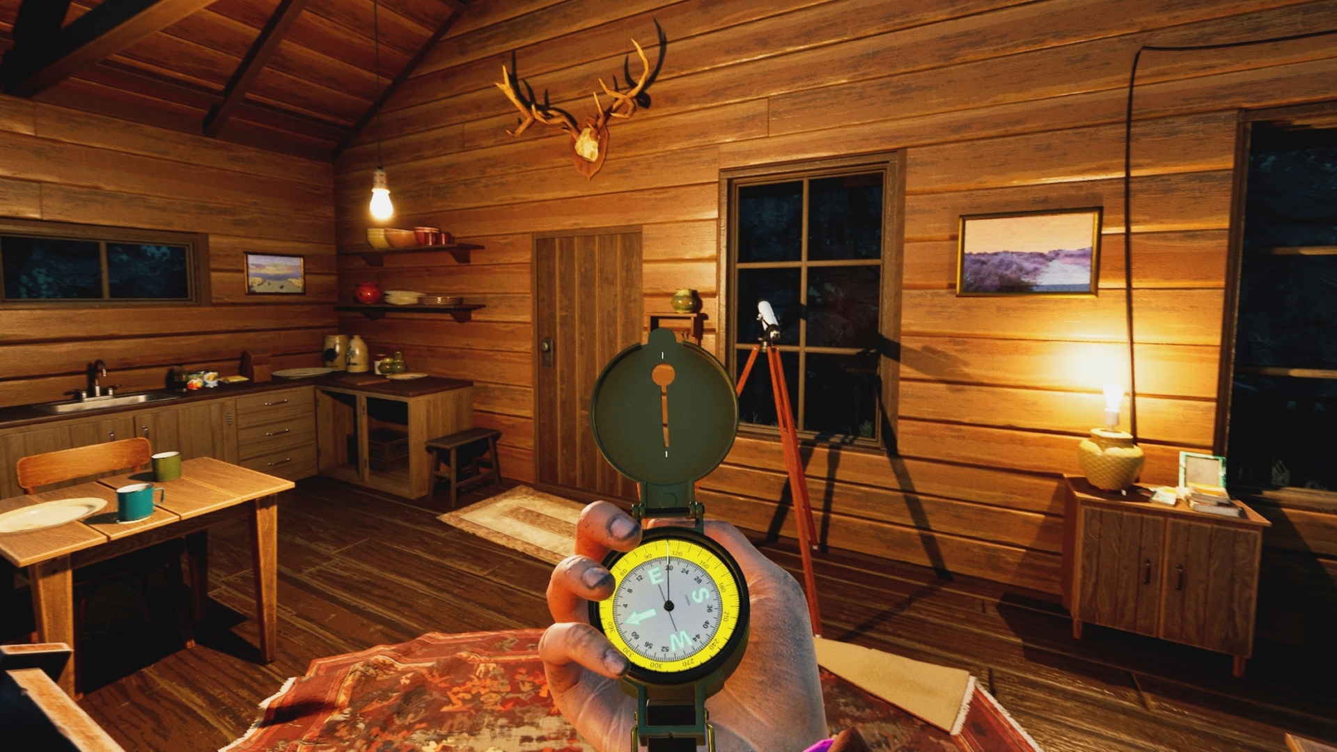 Prologue: A person's hand holding a compass in a cozy log cabin