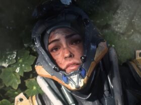 Screenshot of Anthem machine pilot lying on the leafy ground with visor open